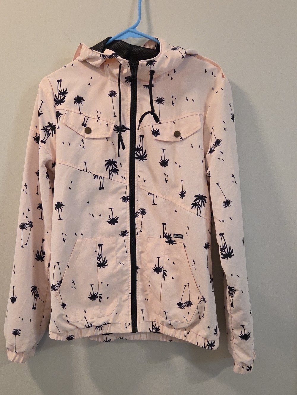 Volcom Enemy Lines Windbreaker Jacket in light pink with a black palm bird print